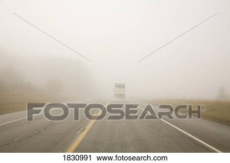 Stock Image - Truck driving in the rain. Fotosearch