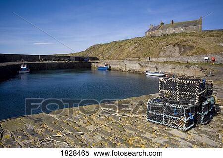 Stock Photography - Trunks on stone dock, Scotland. Fotosearch