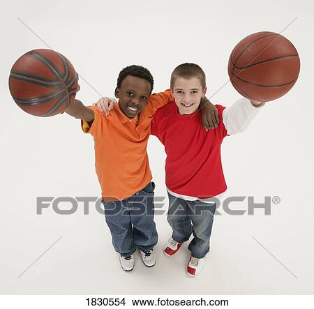 Picture - Two boys holding basketballs. Fotosearch