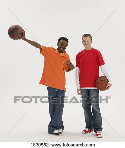 Stock Image - Two boys holding basketballs. Fotosearch