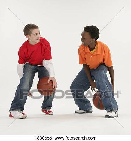 Two boys playing basketball View Large Photo Image Stock Photography - Two boys playing basketball. Fotosearch
