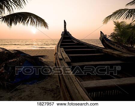 Two canoes on the beach at the Arabian Sea, Kerala, India View Large Photo Image Stock Photo - Two canoes on the beach at the Arabian Sea, Kerala, India . Fotosearch