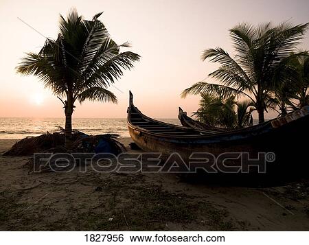 Two canoes on the beach at the Arabian Sea, Kerala, India View Large Photo Image Stock Photograph - Two canoes on the beach at the Arabian Sea, Kerala, India . Fotosearch