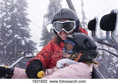 Stock Image - Two skiers on a chairlift, Whistler, BC, Canada. Fotosearch