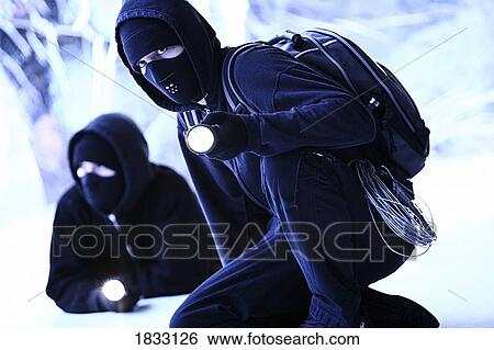 Two thieves dressed in black View Large Photo Image Stock Photograph - Two thieves dressed in black. Fotosearch