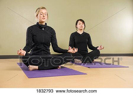Two women meditating View Large Photo Image Stock Image - Two women meditating. Fotosearch