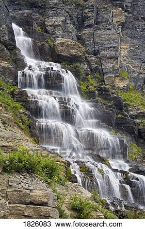 Stock Image - Waterfall near Logan Pass, Glacier National Park, Kalispell, Montana, USA . Fotosearch