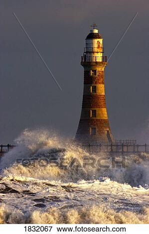 Waves Crashing Against A Lighthouse, Tyne And Wear, England View Large Photo Image Stock Photo - Waves Crashing Against A Lighthouse, Tyne And Wear, England. Fotosearch