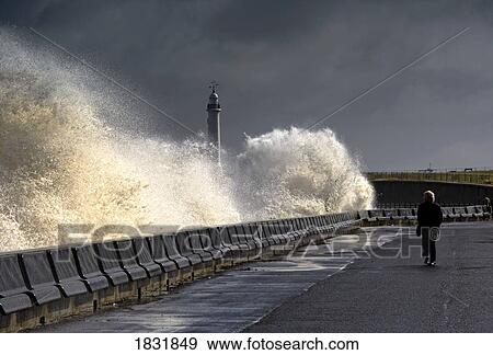 Stock Photo - Waves crashing along a seawall, Sunderland, Tyne and Wear, England. Fotosearch