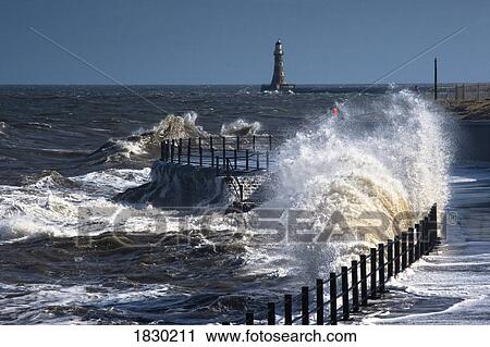 Waves crashing by lighthouse at Sunderland, Tyne and Wear, England View Large Photo Image Stock Image - Waves crashing by lighthouse at Sunderland, Tyne and Wear, England. Fotosearch