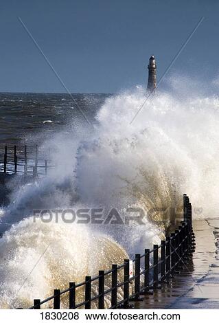 Waves crashing by lighthouse at Sunderland, Tyne and Wear, England View Large Photo Image Stock Photo - Waves crashing by lighthouse at Sunderland, Tyne and Wear, England. Fotosearch