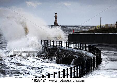 Waves crashing by walk way near lighthouse, Sunderland, Tyne and Wear, England View Large Photo Image Stock Image - Waves crashing by walk way near lighthouse, Sunderland, Tyne and Wear, England. Fotosearch