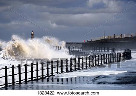 Waves crashing by walk way near lighthouse, Sunderland, Tyne and Wear, England View Large Photo Image Stock Image - Waves crashing by walk way near lighthouse, Sunderland, Tyne and Wear, England. Fotosearch