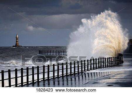 Waves crashing by walk way near lighthouse, Sunderland, Tyne and Wear, England View Large Photo Image Stock Image - Waves crashing by walk way near lighthouse, Sunderland, Tyne and Wear, England. Fotosearch