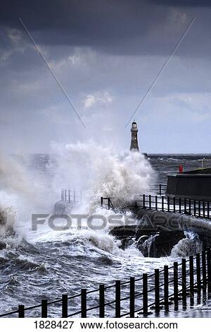 Waves crashing by walk way near lighthouse, Sunderland, Tyne and Wear, England View Large Photo Image Stock Photo - Waves crashing by walk way near lighthouse, Sunderland, Tyne and Wear, England. Fotosearch
