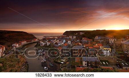 Wide angle cityscape at sunset, Staithes, Yorkshire, England View Large Photo Image Stock Image - Wide angle cityscape at sunset, Staithes, Yorkshire, England. Fotosearch