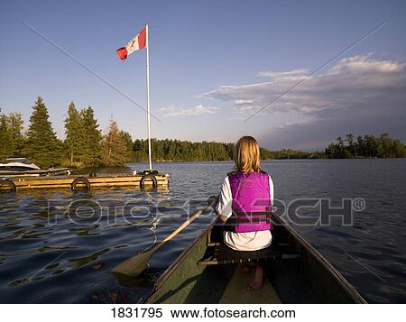 Stock Photography - Woman canoeing. Fotosearch