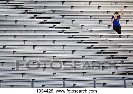 Woman in the bleachers View Large Photo Image Stock Photo - Woman in the bleachers. Fotosearch