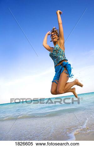 Stock Photography - Woman jumping at the beach, Playa del Carmen, Mayan Riviera, Mexico. Fotosearch