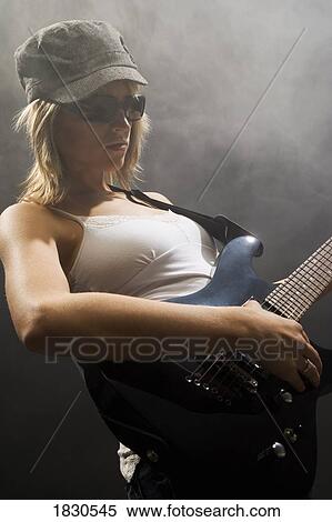 Woman playing the guitar View Large Photo Image Stock Photography - Woman playing the guitar. Fotosearch