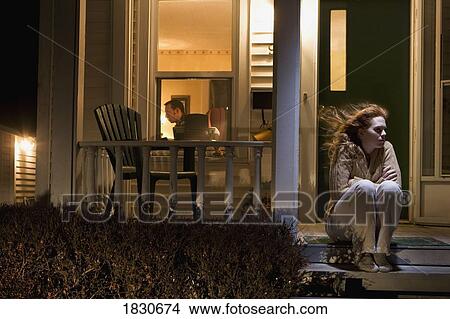 Woman sitting outside of her house View Large Photo Image Picture - Woman sitting outside of her house. Fotosearch