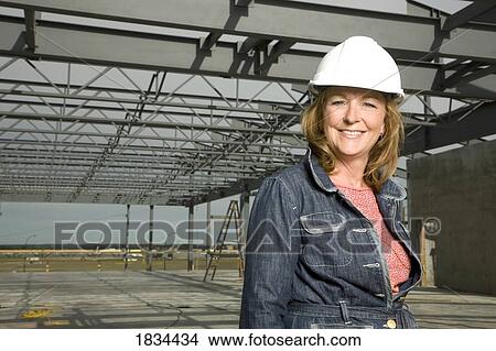 Picture - Woman wearing a hard hat. Fotosearch