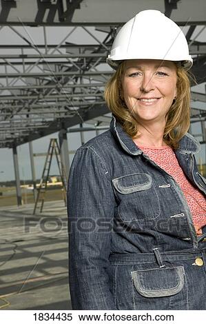 Woman wearing a hard hat View Large Photo Image Stock Photography - Woman wearing a hard hat. Fotosearch