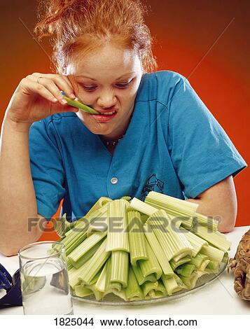 Picture - Woman with a plate of celery. Fotosearch