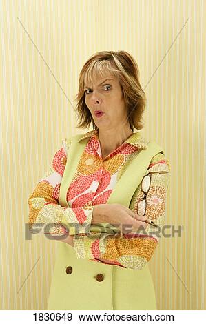 Stock Photo - Woman with a raised eyebrow and pursed lips. Fotosearch