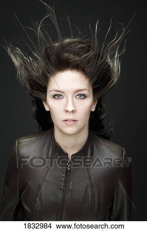 Woman with wind blown hair View Large Photo Image Picture - Woman with wind blown hair. Fotosearch