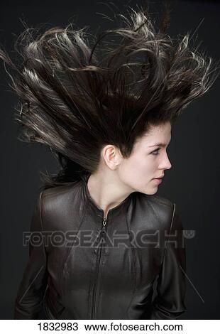 Stock Image - Woman with wind blown hair. Fotosearch