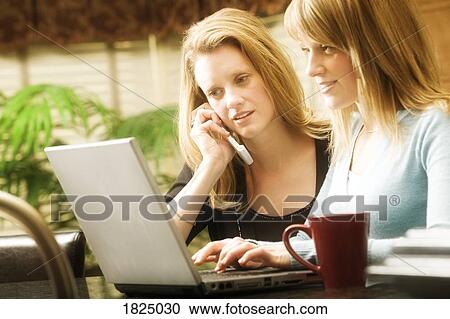 Stock Image - Women on the phone and computer. Fotosearch