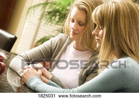Stock Image - Women praying together. Fotosearch