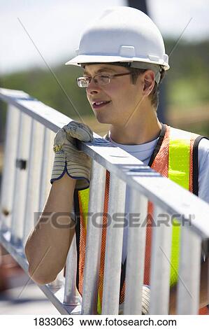 Worker carrying a ladder View Large Photo Image Stock Image - Worker carrying a ladder. Fotosearch