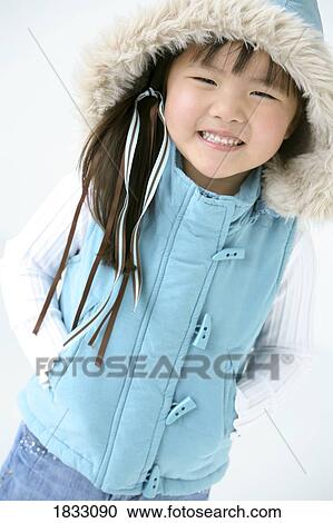 Stock Image - Young girl in winter clothing. Fotosearch