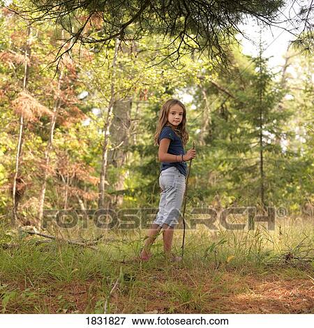 Young girl in woods View Large Photo Image Stock Photo - Young girl in woods. Fotosearch