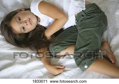 Young girl lying down View Large Photo Image Stock Image - Young girl lying down. Fotosearch