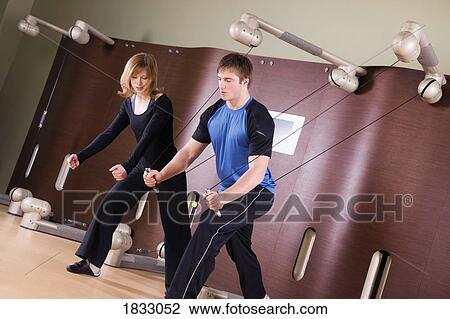 Stock Image - Young people working out together. Fotosearch