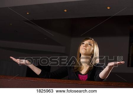Young woman with her arms raised View Large Photo Image Stock Image - Young woman with her arms raised. Fotosearch