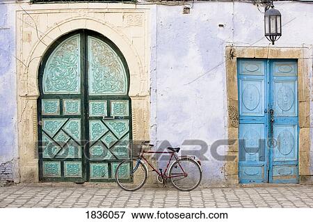 Bicycle and blue doors, Kairouan, Tunisia, Africa View Large Photo Image Stock Photo - Bicycle and blue doors, Kairouan, Tunisia, Africa . Fotosearch