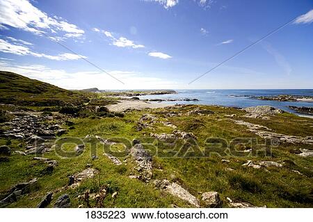 Stock Image - Blue sky over coast, Inner Hebrides, Scotland. Fotosearch