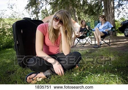 Stock Image - Bored on a camping trip. Fotosearch