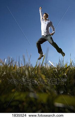 Picture - Boy jumping for joy. Fotosearch