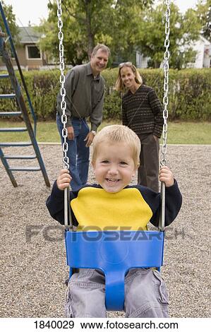 Stock Photo - Boy on a swing. Fotosearch
