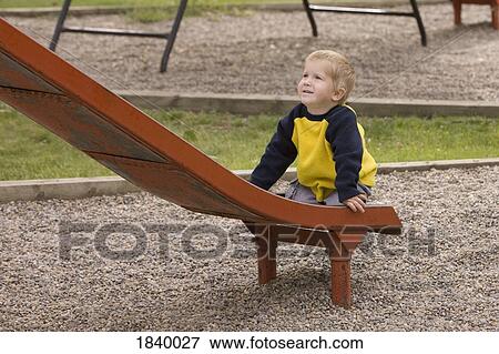 Stock Photo - Boy playing at a park. Fotosearch