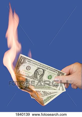 Stock Photo - Burning American money. Fotosearch