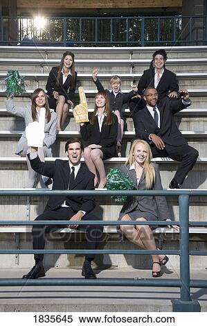 Stock Photography - Business people cheering in the stands. Fotosearch