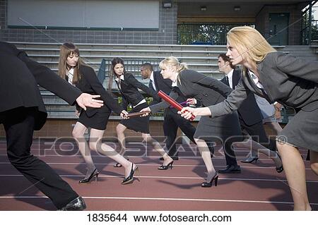 Picture - Business people passing the baton. Fotosearch