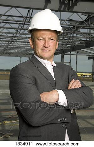 Stock Image - Businessman at a new building. Fotosearch