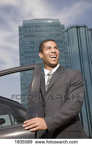 Businessman getting in car View Large Photo Image Stock Photo - Businessman getting in car. Fotosearch